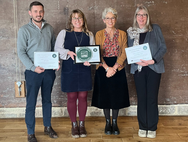Four people holding CPRE award certificates